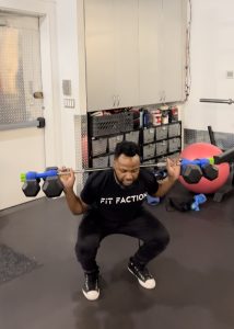 man doing barbell squats with Dualbell